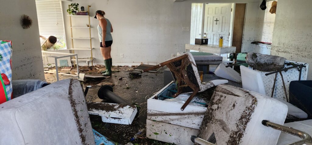 Destination Wedding Photographer Julie Ferneau going through her damaged items after hurricane Ian.