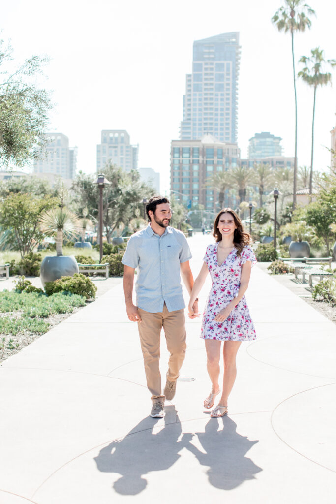 Newly engaged couple at the Headquarters at Seaport Village San Diego posing for engagement photos taken by luxury destination wedding photographer Julie Ferneau
