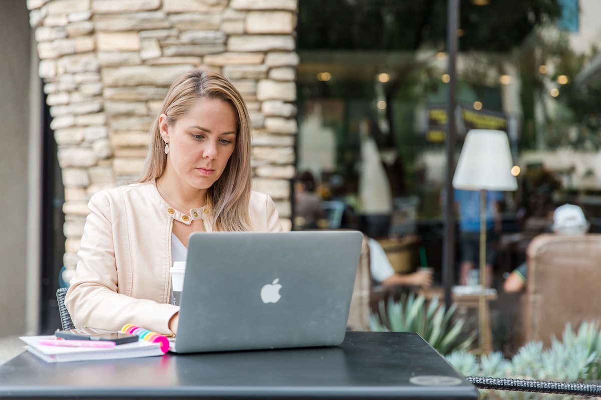 Female entrepreneur working on her laptop during a brand photography session in Fort Myers, Florida